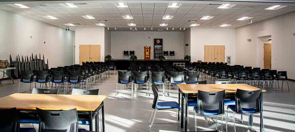 Centre of Excellence large room rental with stage. Sound proof divider converts space into two rooms.