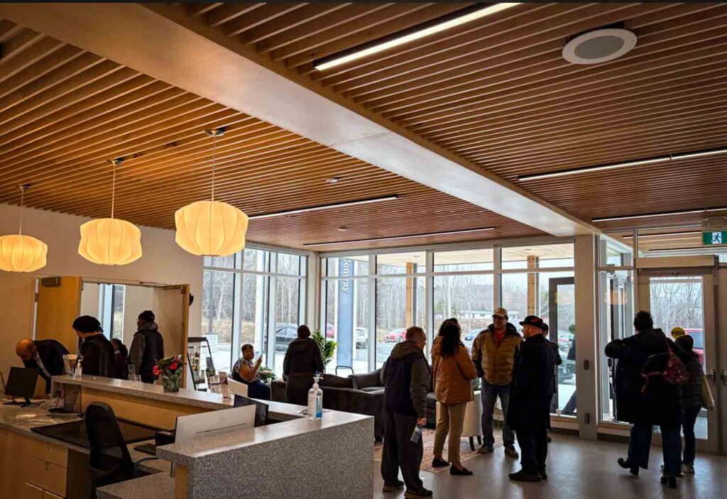 Lobby of Jordontown Acaciaville Conway Centre of Excellence. People are meeting with another.