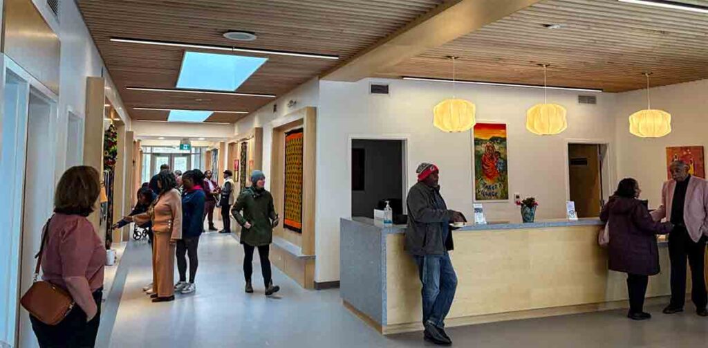 Lobby area and hallway of JACCOE. People are in conversation.